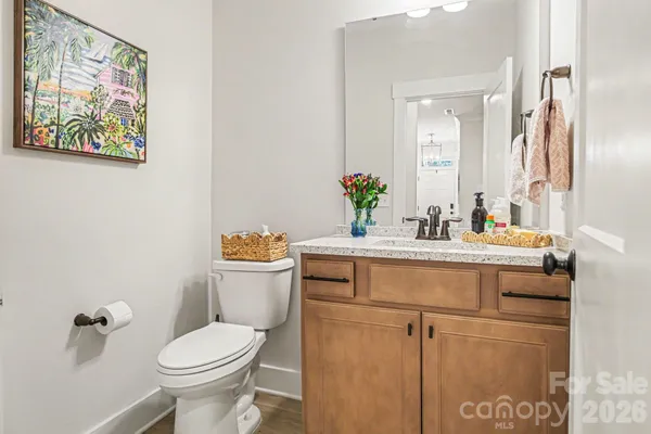 a bathroom with a sink mirror vanity and toilet