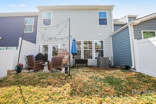 a backyard of a house with barbeque oven table and chairs