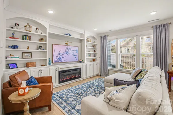 a living room with furniture a rug and a fireplace