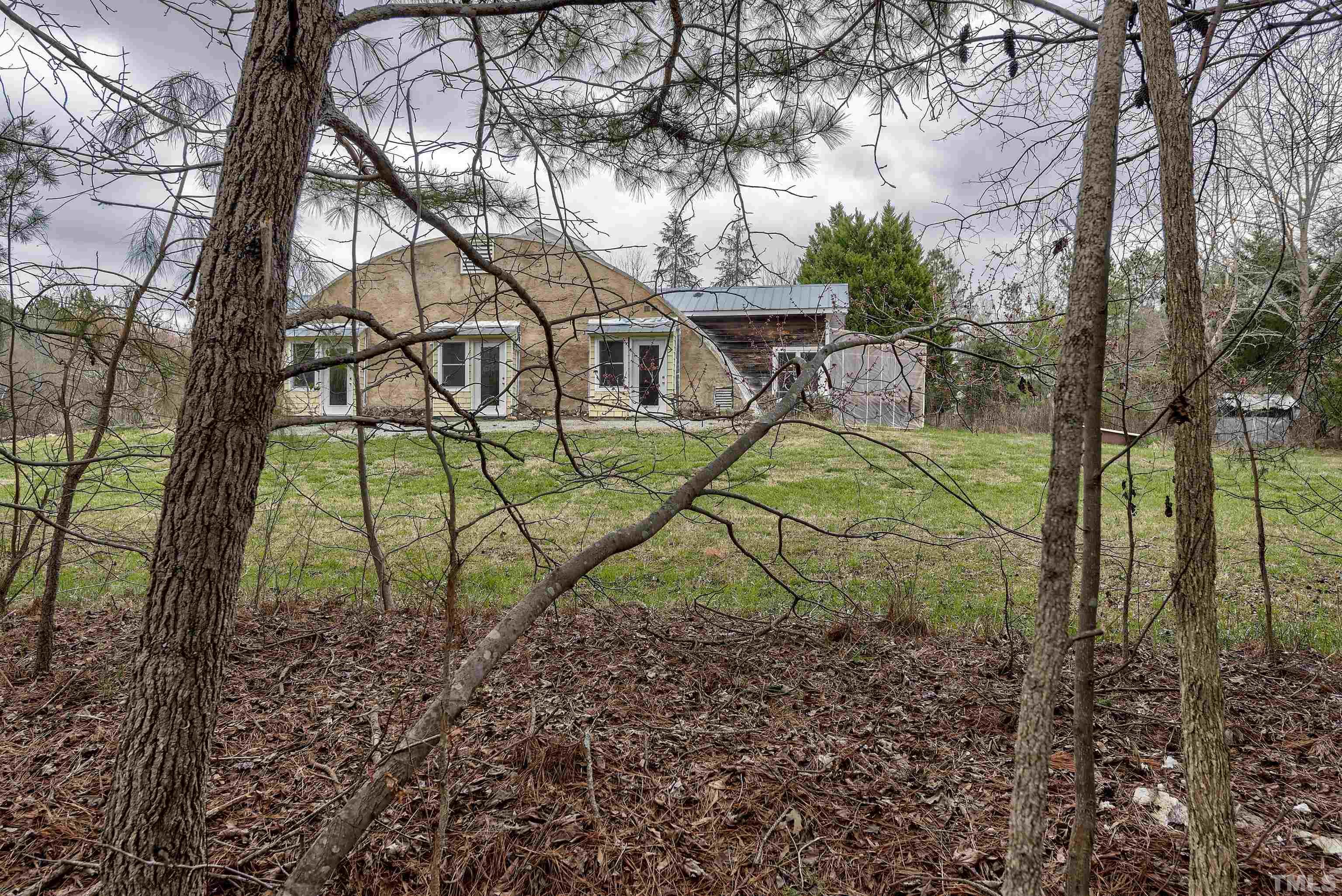 7409 Wiley Mangum Road Bahama, NC 27503 - Photo 5 of 20 a view of a house with a yard and a tree