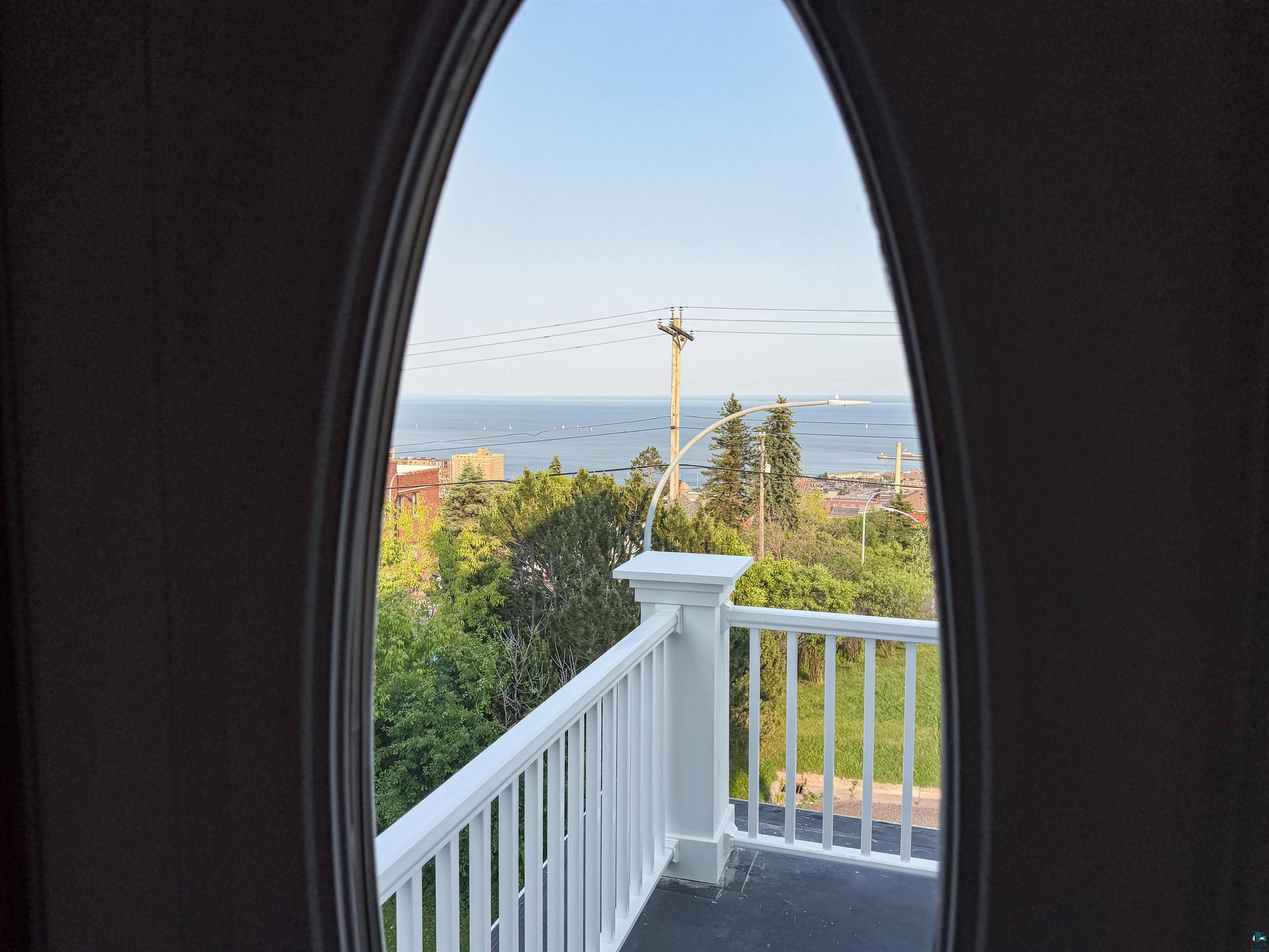 13 West 8th Street Duluth, MN 55806 - Photo 29 of 57 Balcony with white railing and water visible in the background