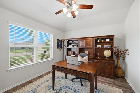 a living room with furniture a table and a large window