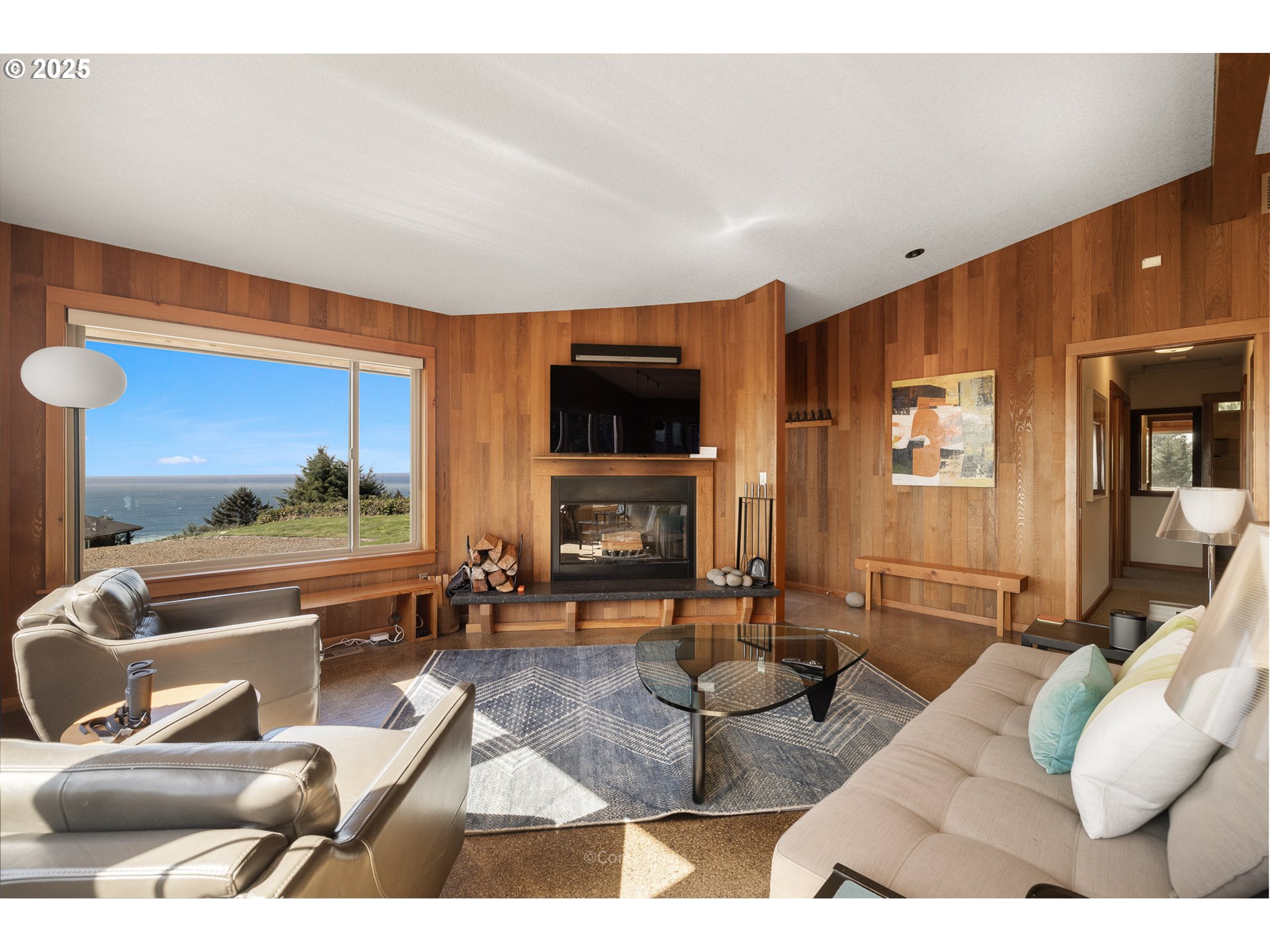 8455 San Dune Road Nehalem, OR 97131 - Photo 13 of 48 a living room with furniture and a flat screen tv