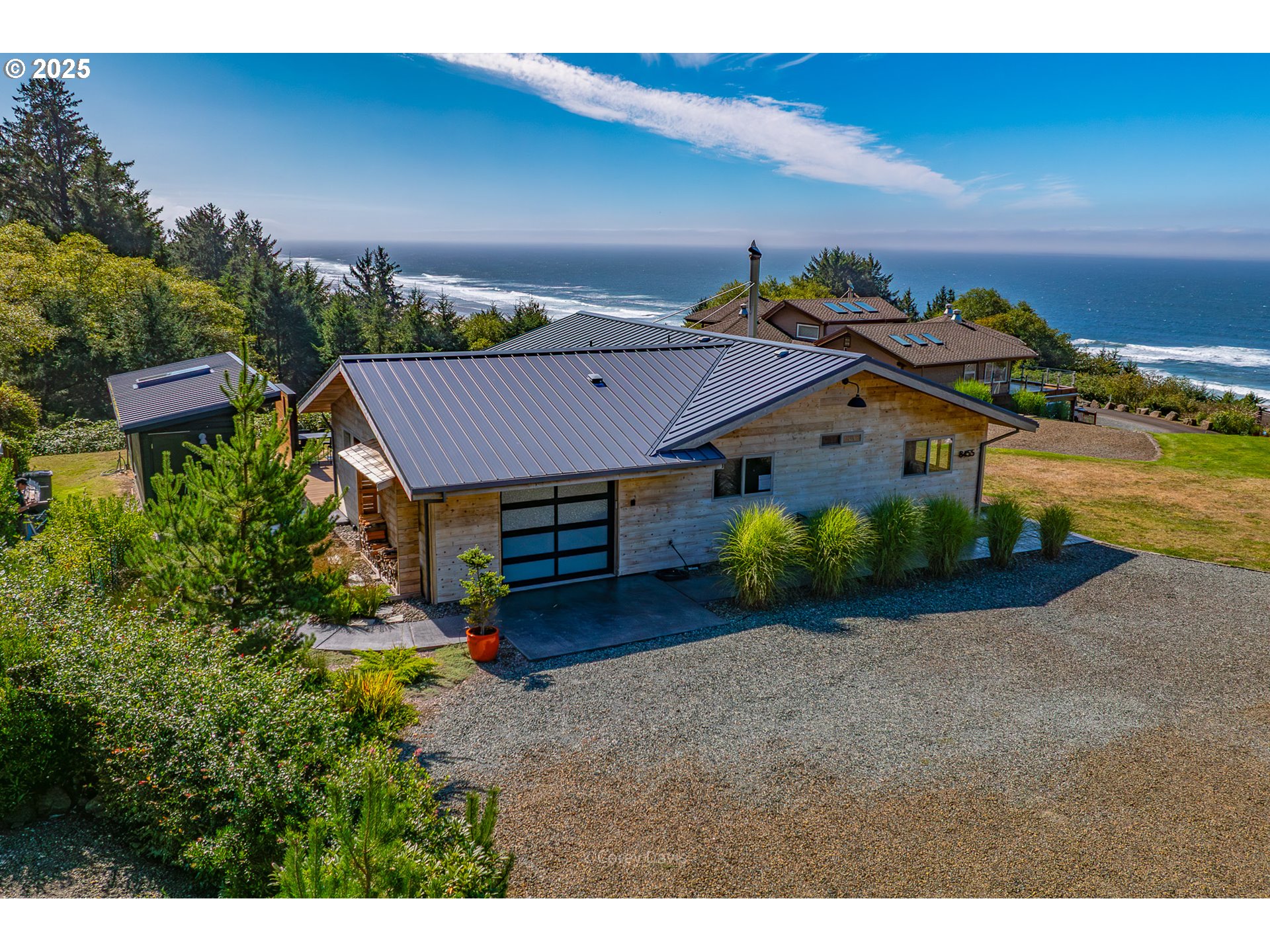 8455 San Dune Road Nehalem, OR 97131 - Photo 3 of 48 a view of a house with a yard and garage