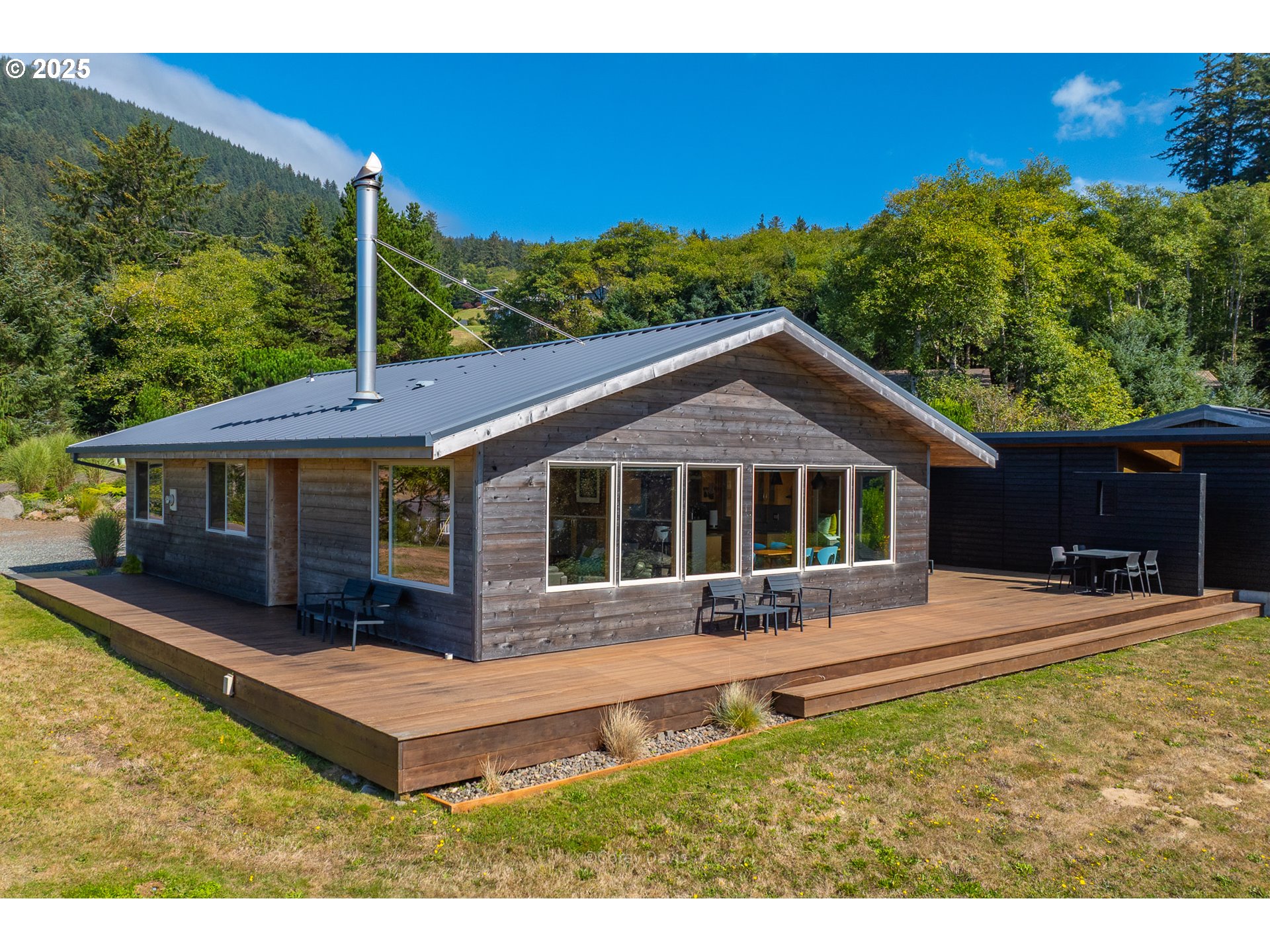 8455 San Dune Road Nehalem, OR 97131 - Photo 33 of 48 a front view of a house with a yard