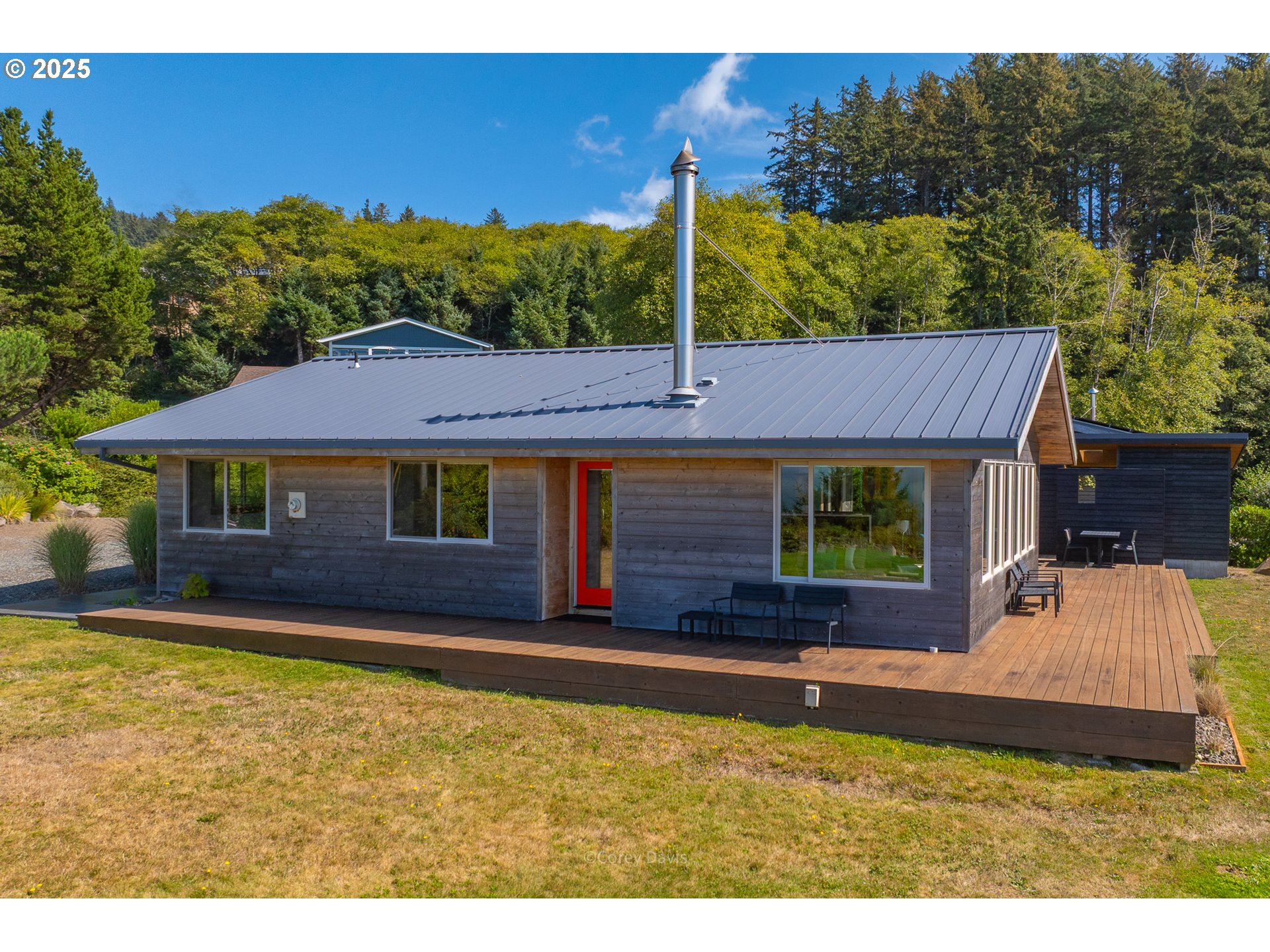 8455 San Dune Road Nehalem, OR 97131 - Photo 40 of 48 a view of house with garden space and a car park in front of it