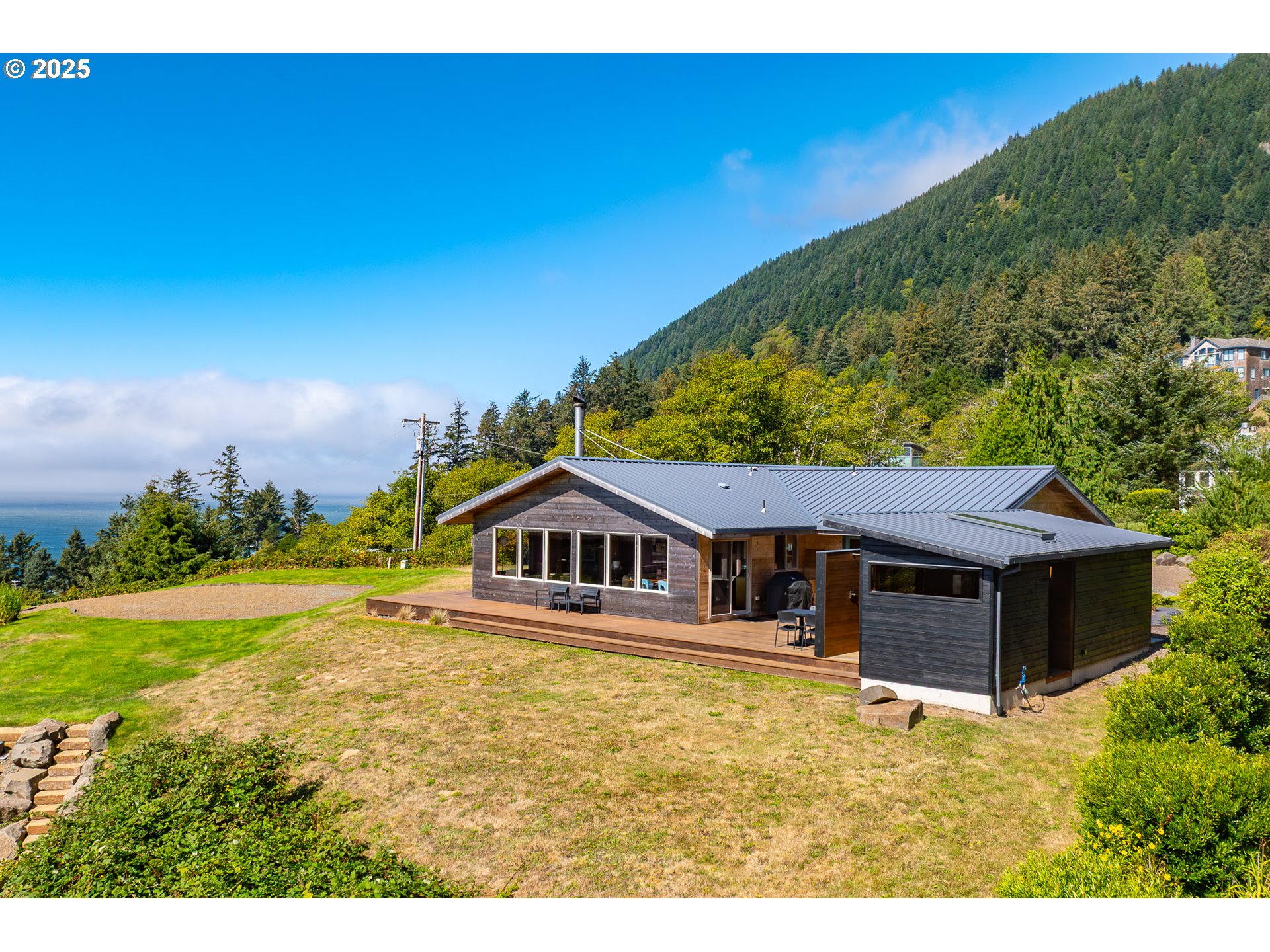 8455 San Dune Road Nehalem, OR 97131 - Photo 4 of 48 a view of a house with a big yard