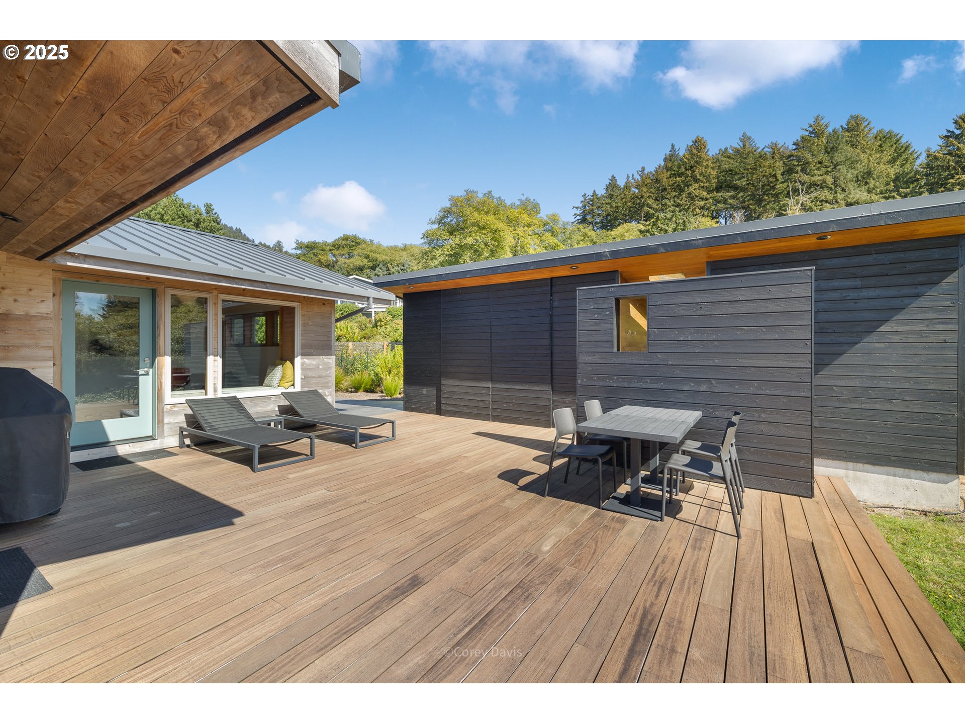 8455 San Dune Road Nehalem, OR 97131 - Photo 45 of 48 a balcony with wooden floor and outdoor seating