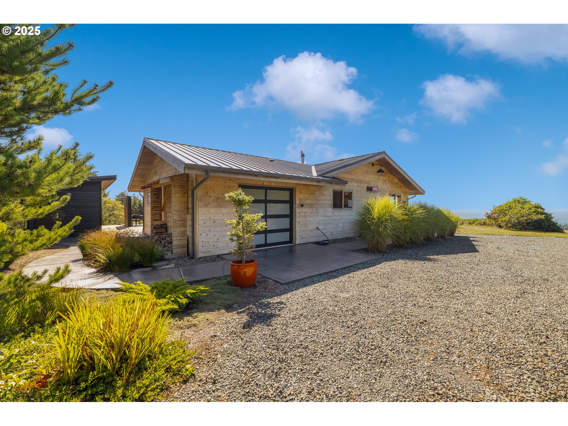 8455 San Dune Road Nehalem, OR 97131 - Photo 7 of 48 a view of a house with backyard and sitting area