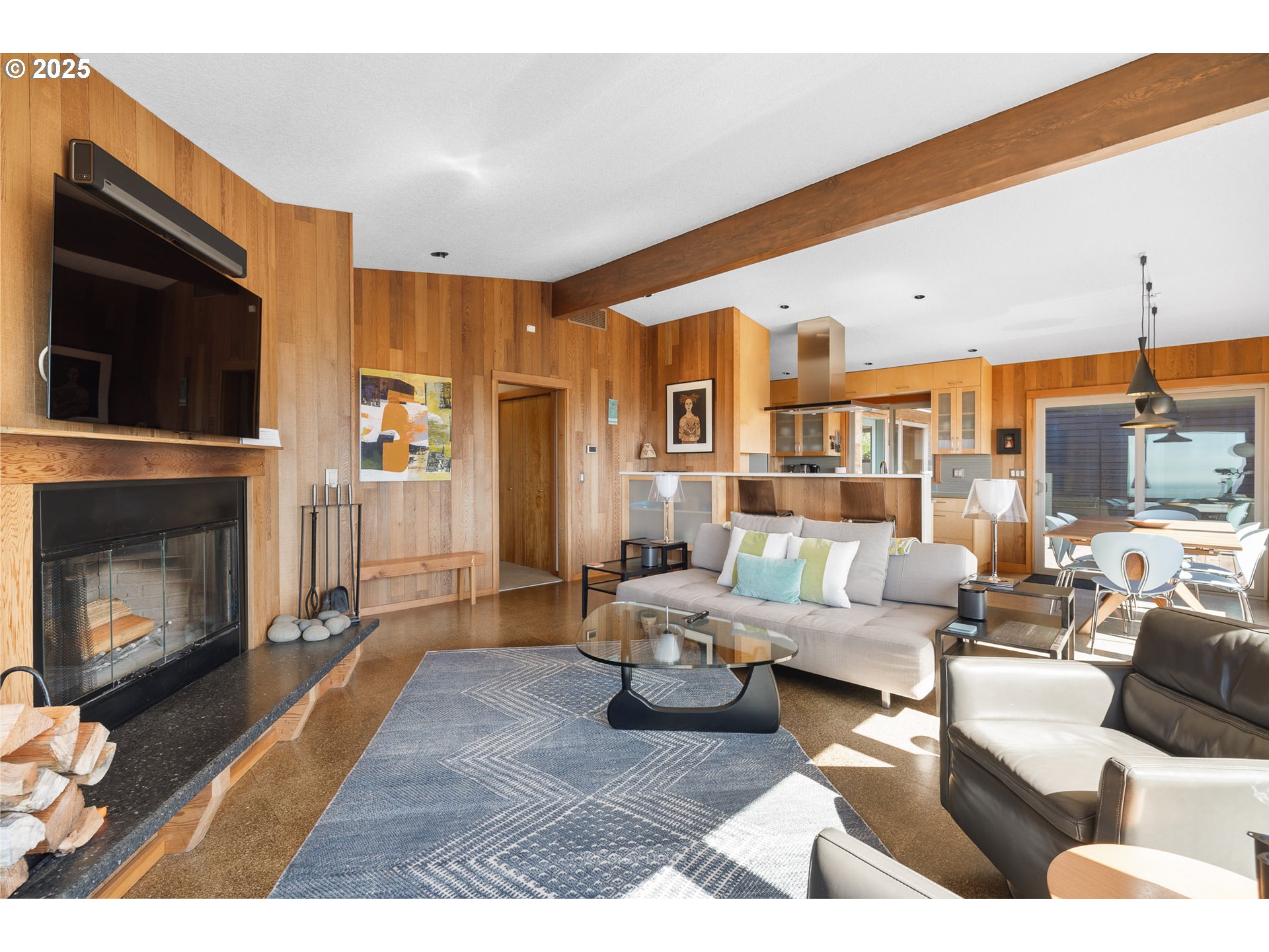 8455 San Dune Road Nehalem, OR 97131 - Photo 10 of 48 a living room with furniture kitchen view and a fireplace