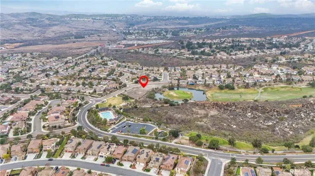 an aerial view of a houses with a yard and lake view