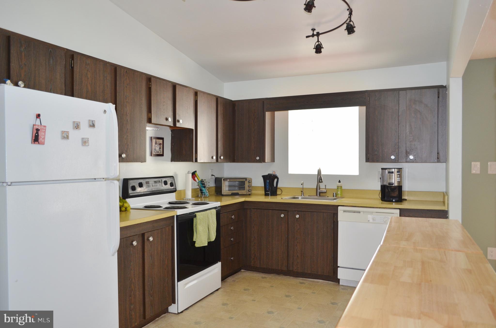 1365 Moyer Road Annapolis, MD 21403 - Photo 6 of 23 a kitchen with stainless steel appliances a sink a stove a refrigerator cabinets and a window