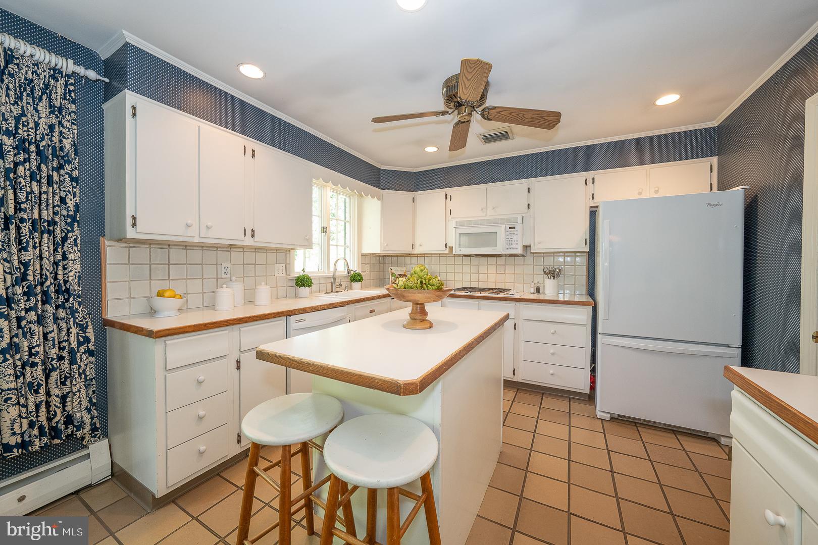 340 Chester Road Devon, PA 19333 - Photo 18 of 48 a kitchen with a sink a refrigerator and cabinets