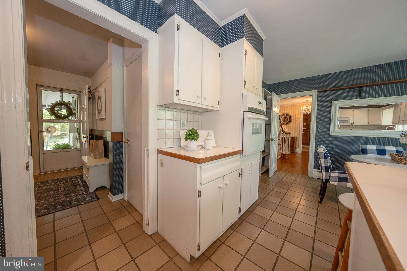 340 Chester Road Devon, PA 19333 - Photo 19 of 48 a kitchen with white cabinets and appliances