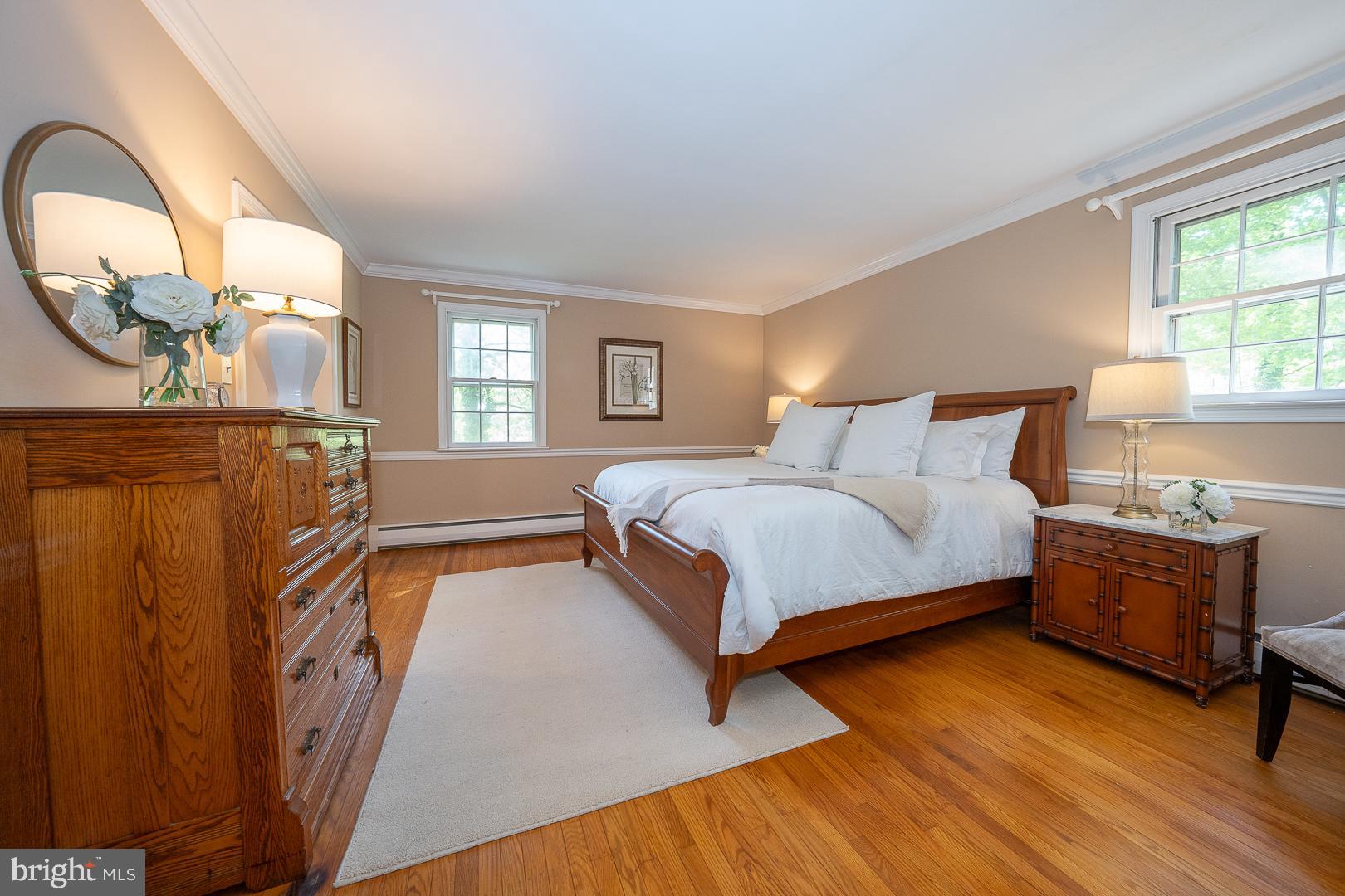 340 Chester Road Devon, PA 19333 - Photo 27 of 48 a bedroom with a bed and a dresser next to a window