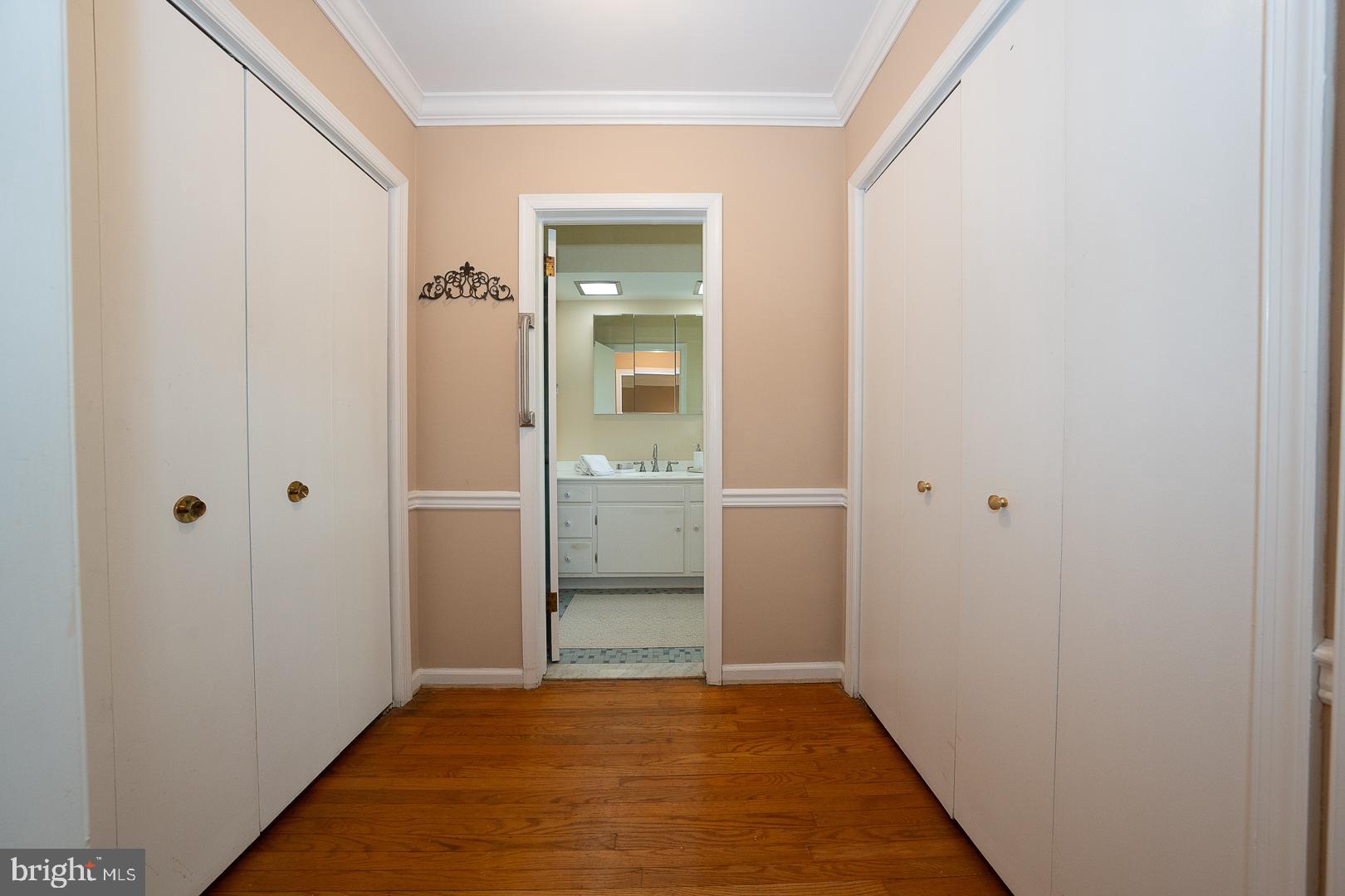 340 Chester Road Devon, PA 19333 - Photo 28 of 48 a view of a hallway with wooden floor and a bathroom