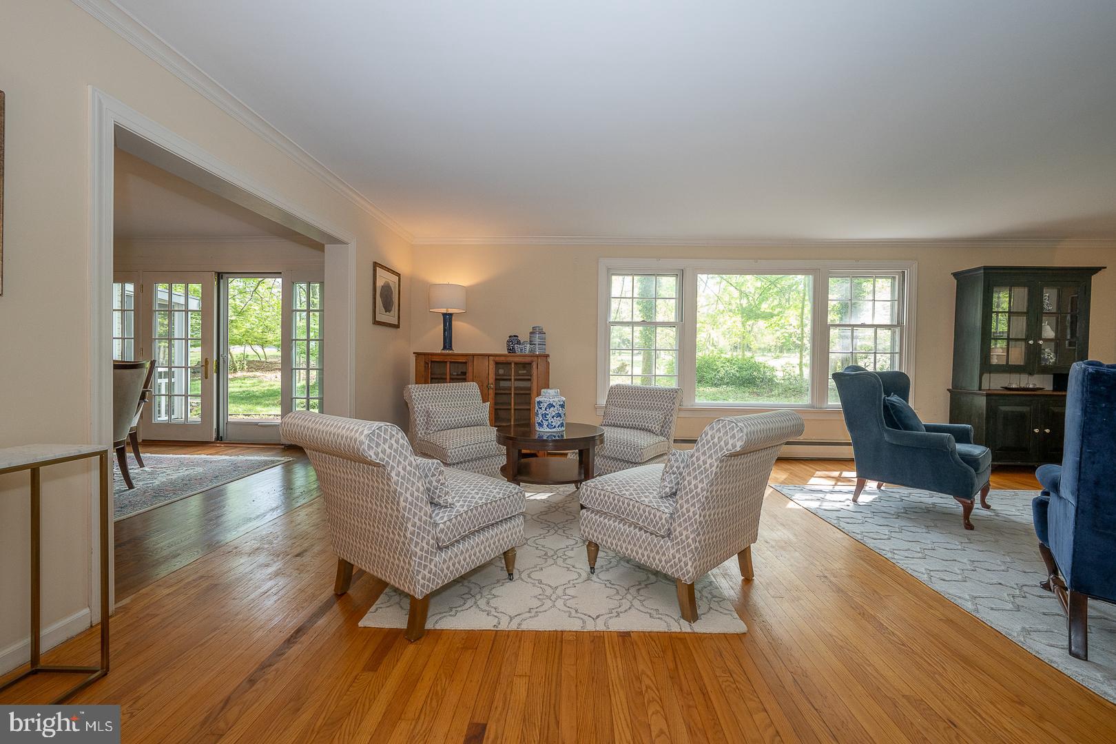 340 Chester Road Devon, PA 19333 - Photo 8 of 48 a living room with fireplace furniture wooden floor and a large window