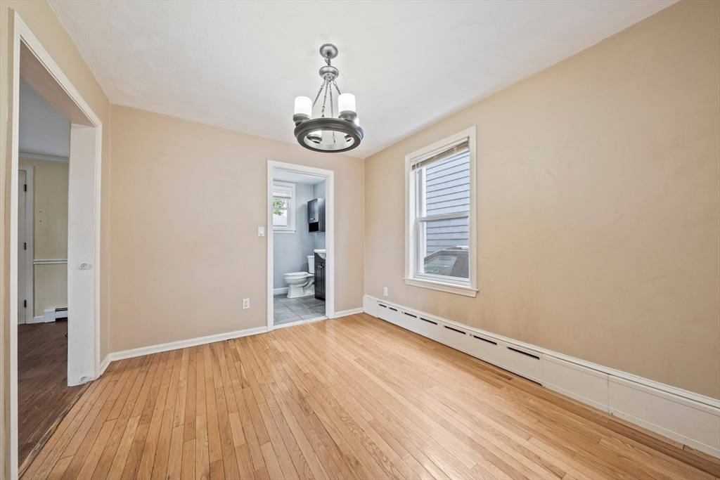 26 Sherman Road Braintree, MA 02184 - Photo 11 of 42 a view of an empty room with wooden floor and a window