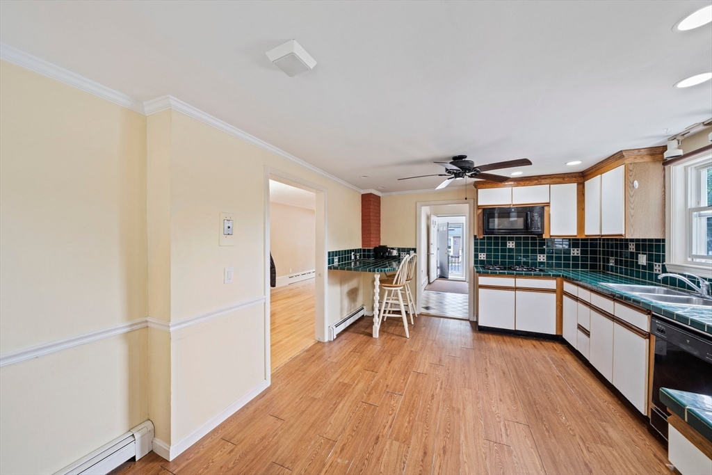 26 Sherman Road Braintree, MA 02184 - Photo 13 of 42 a kitchen with stainless steel appliances granite countertop a stove and a refrigerator