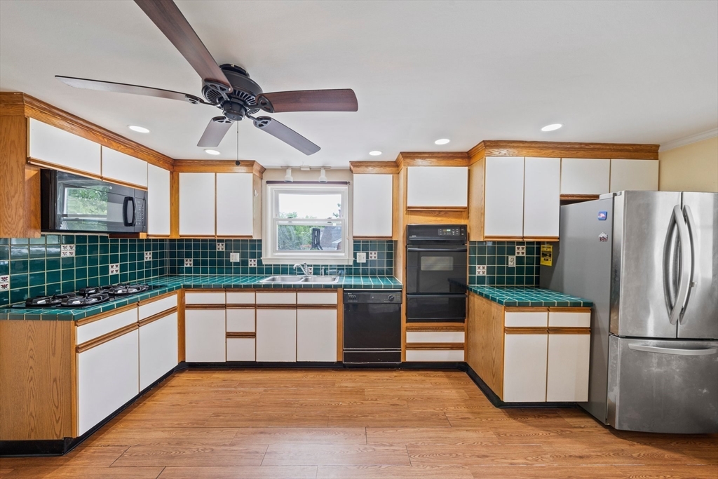 26 Sherman Road Braintree, MA 02184 - Photo 14 of 42 a kitchen with stainless steel appliances granite countertop a refrigerator and a stove top oven