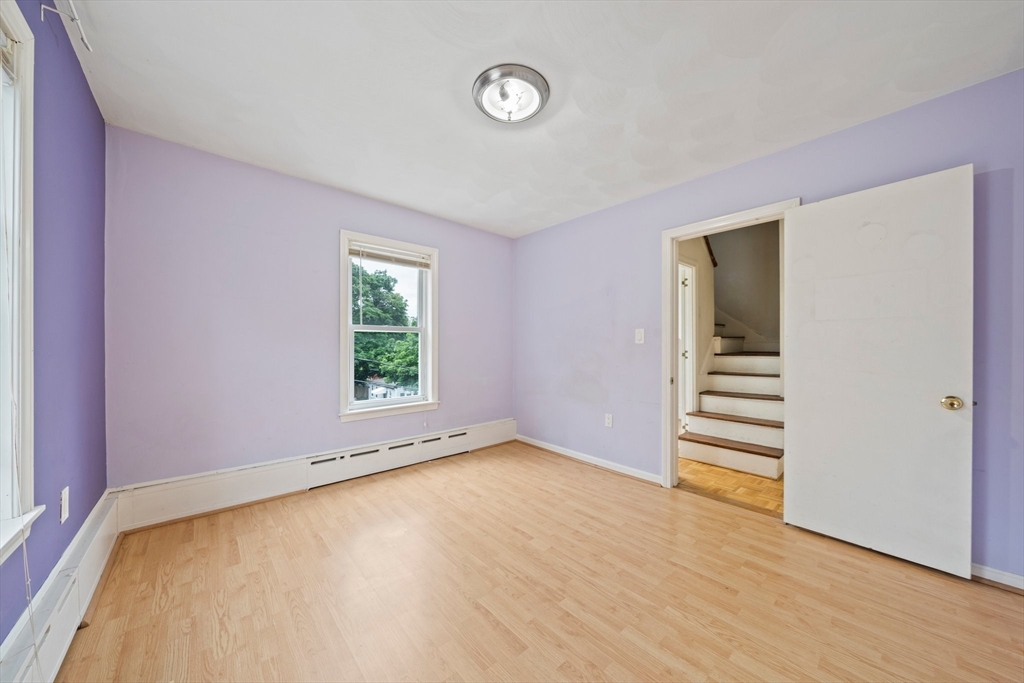 26 Sherman Road Braintree, MA 02184 - Photo 25 of 42 a view of an empty room with a window and wooden floor