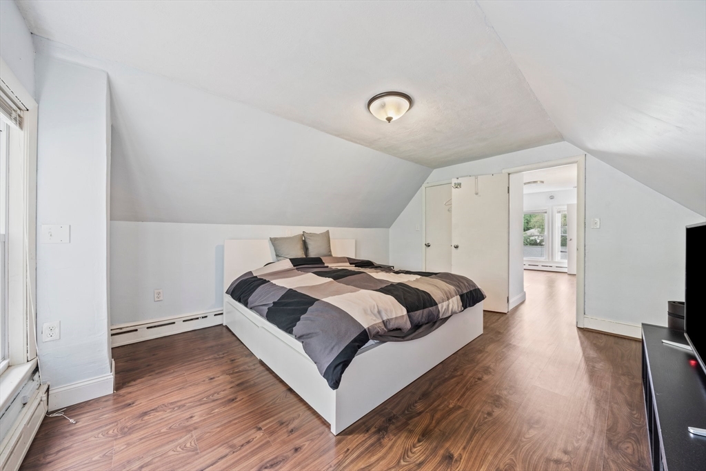 26 Sherman Road Braintree, MA 02184 - Photo 26 of 42 a bedroom with a bed and wooden floor