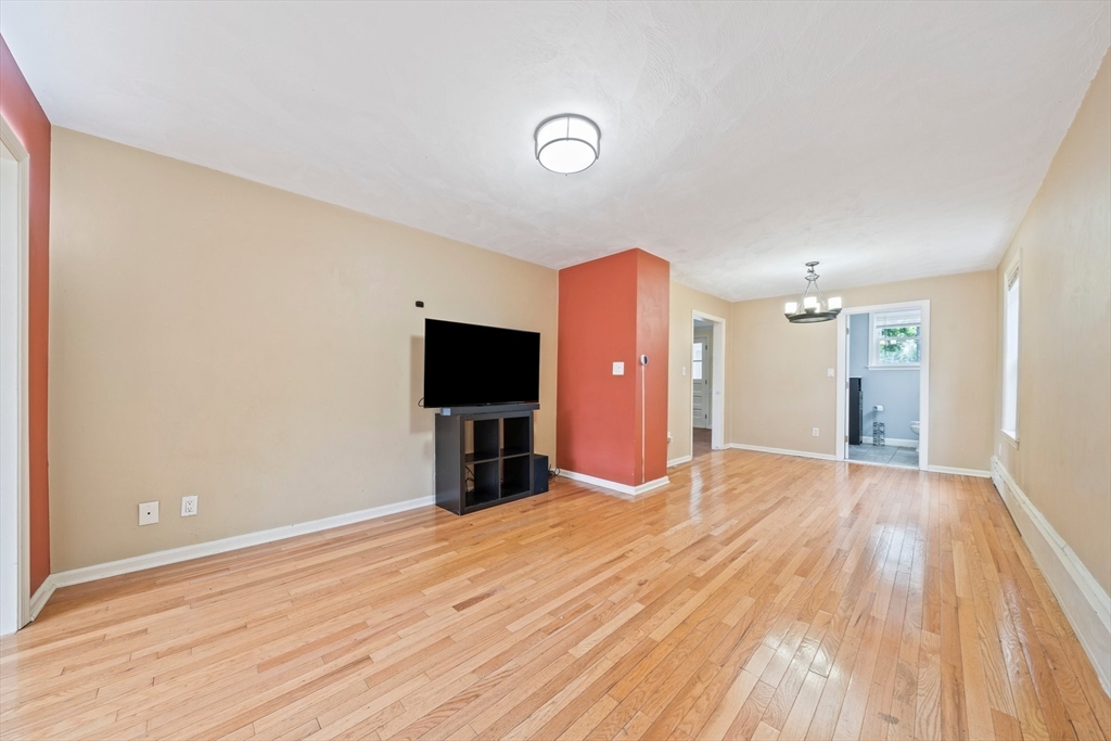 26 Sherman Road Braintree, MA 02184 - Photo 5 of 42 a view of a livingroom with wooden floor and a flat screen tv