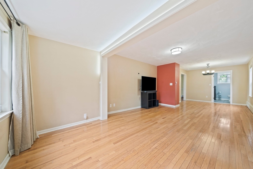 26 Sherman Road Braintree, MA 02184 - Photo 8 of 42 a view of an empty room with wooden floor and a window