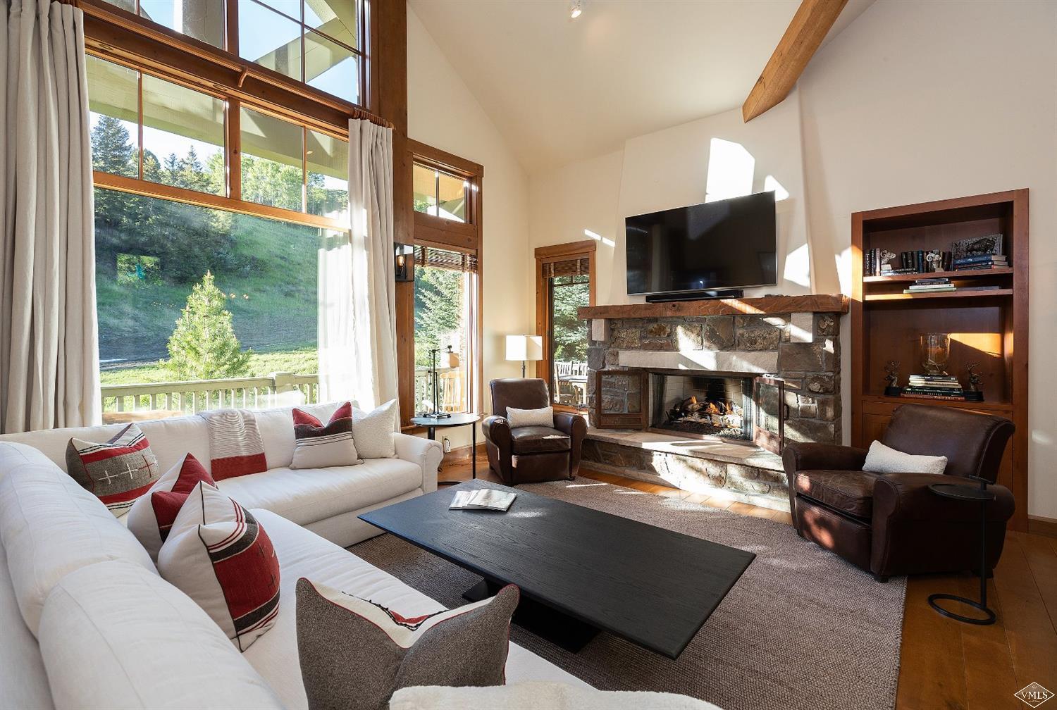 a living room with fireplace furniture and a flat screen tv