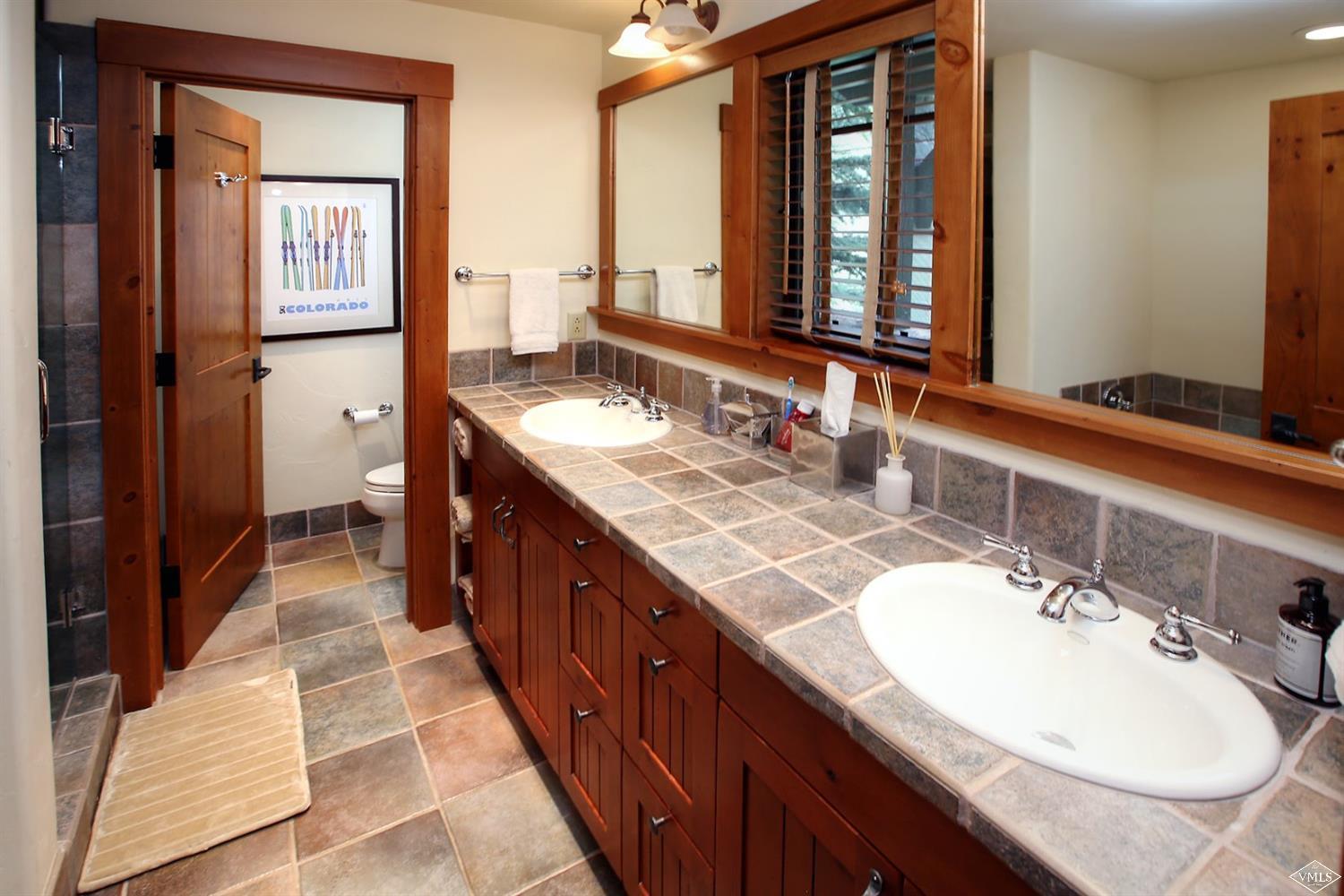 404 Cresta Road Edwards, CO 81632 - Photo 14 of 25 a bathroom with a double vanity sink and a mirror