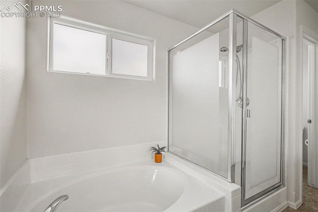 12210 Crystal Downs Road Peyton, CO 80831 - Photo 18 of 40 a bathroom with a shower and a tub