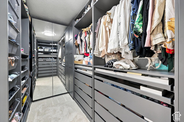 7939 Seattle Slew Road Eagle Mountain, UT 84005 - Photo 19 of 52 Custom built-in closet system with extensive shelving, multiple drawer units, hanging rods, and integrated full-length mirrors