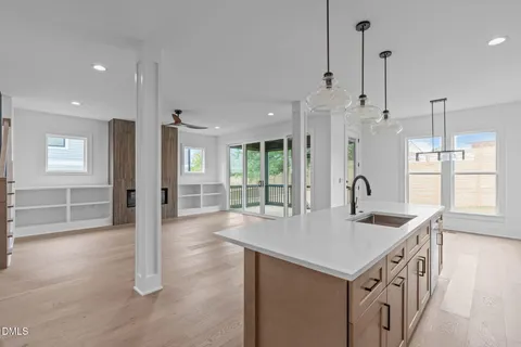 a kitchen with stainless steel appliances granite countertop a sink a refrigerator and a window