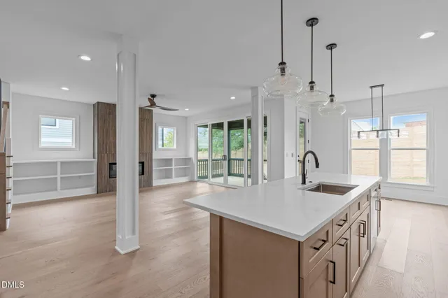 a kitchen with stainless steel appliances granite countertop a sink a refrigerator and a window