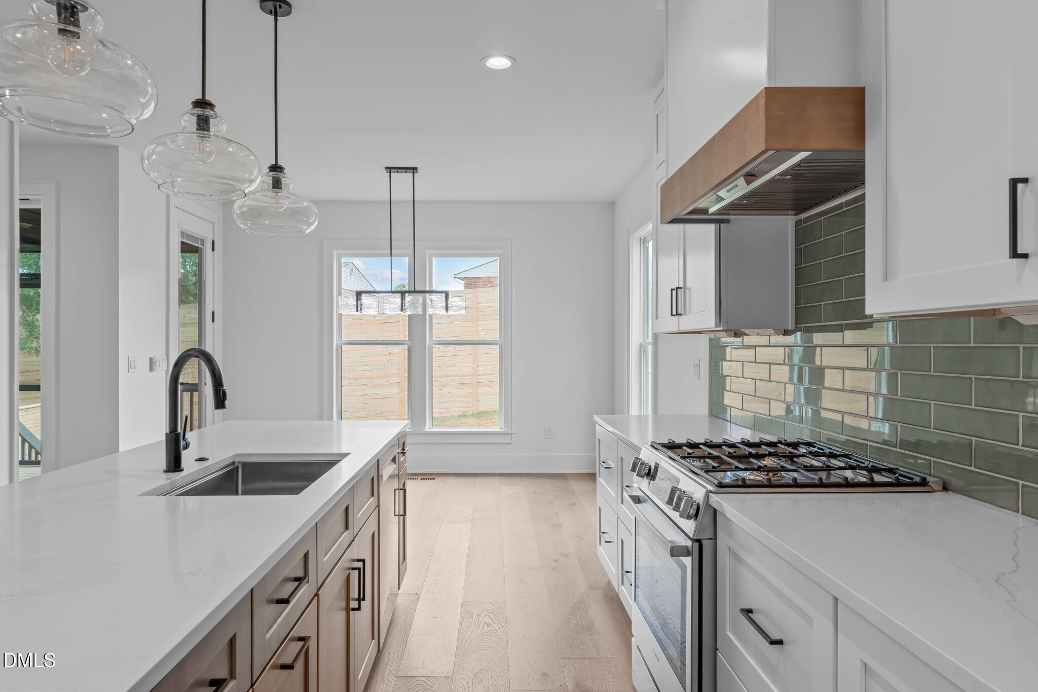 1012 Addison Place Raleigh, NC 27610 - Photo 11 of 56 a kitchen that has a sink a stove and a window