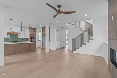 a kitchen with a sink a stove a refrigerator and cabinets