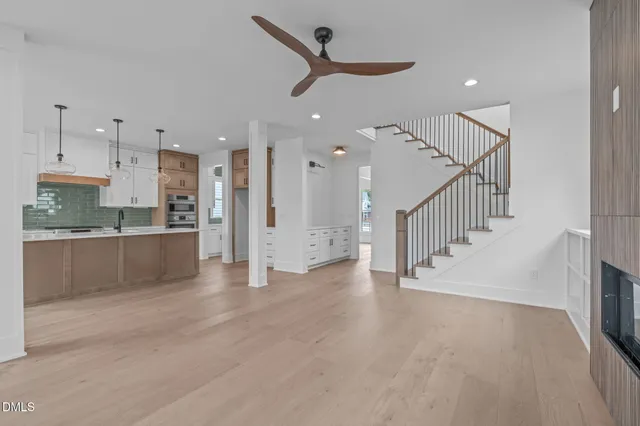a kitchen with a sink a stove a refrigerator and cabinets
