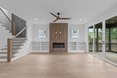 a view of an empty room with wooden floor and cabinet