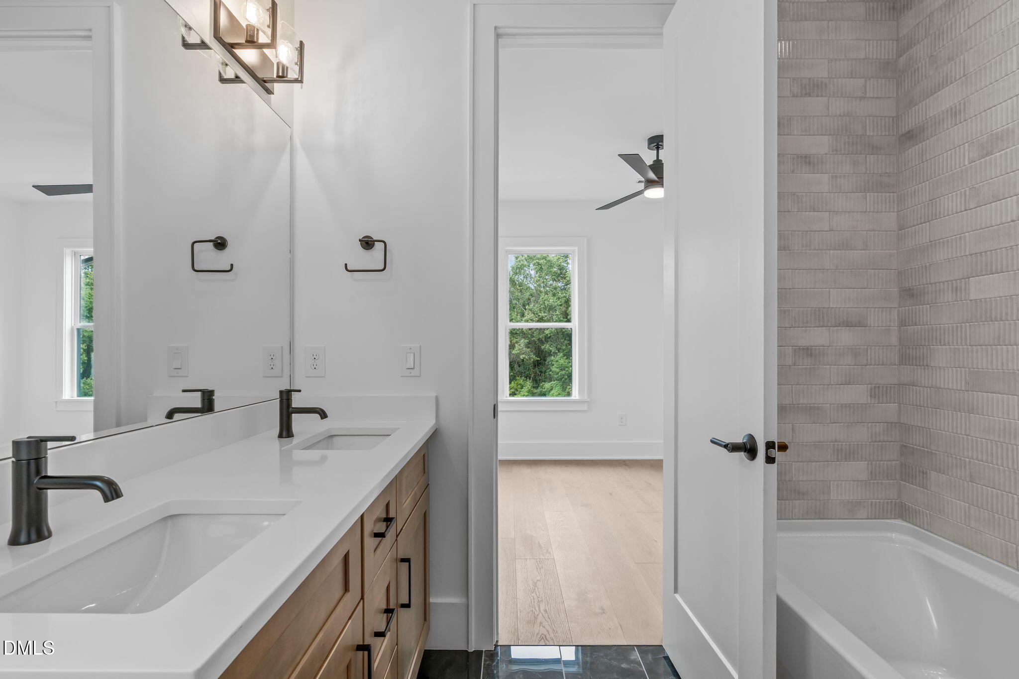 1012 Addison Place Raleigh, NC 27610 - Photo 31 of 56 a bathroom with a granite countertop sink a mirror and a bathtub