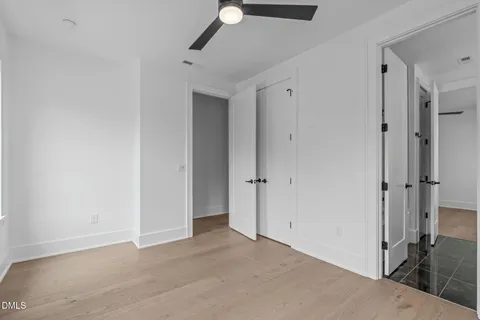 a kitchen with white cabinets and sink