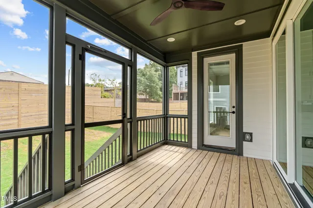 an aerial view of residential houses with outdoor space and parking