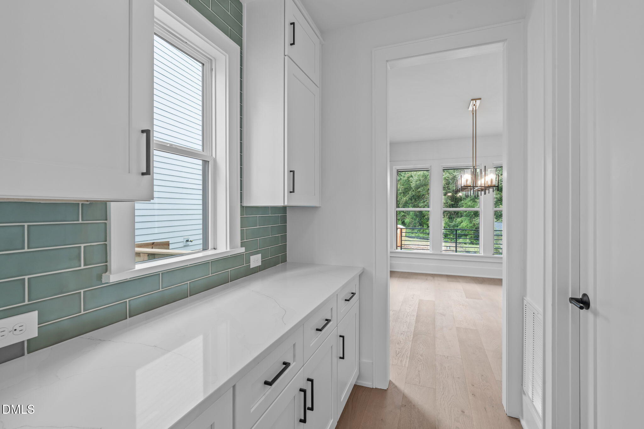 1012 Addison Place Raleigh, NC 27610 - Photo 7 of 56 a view of cabinets a window and a wooden floor