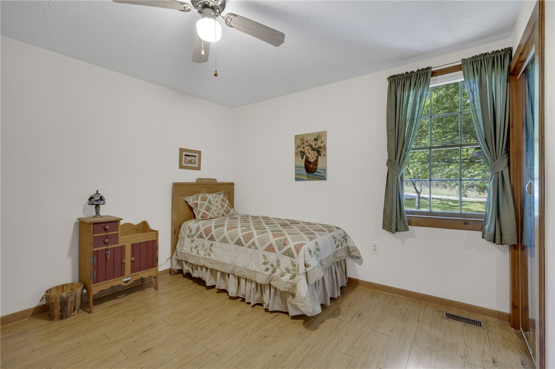 437 West Gate Road Pickens, SC 29671 - Photo 45 of 47 This cozy bedroom offers serene views through a classic window, enhancing its comfortable and peaceful ambiance.