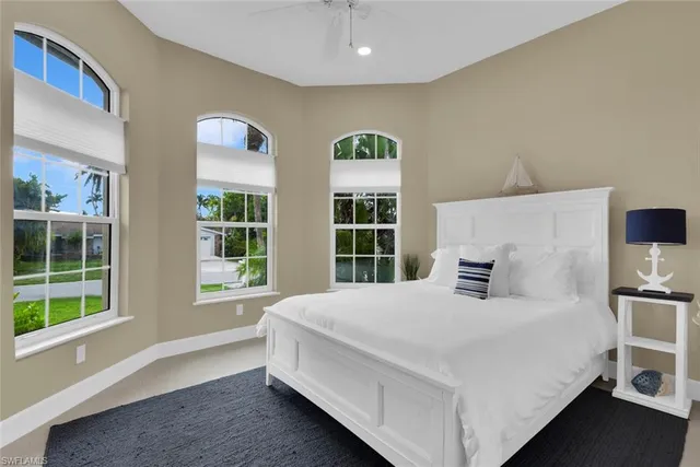 a bedroom with a large bed and a window