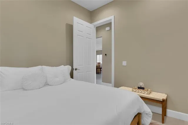 a bedroom with a bed and a table