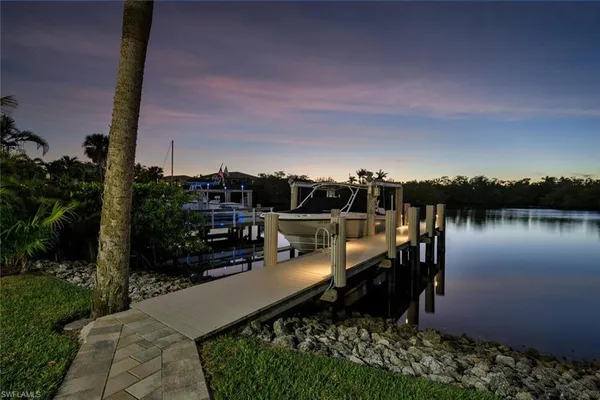 a view of a lake with a house in the background