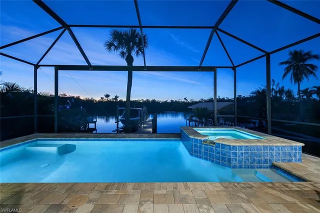 a view of a patio with a table and chairs under an umbrella