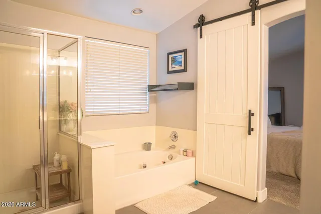 a bathroom with a bathtub and a shower