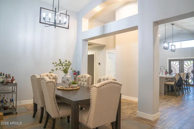 a dining room with furniture wooden floor and a chandelier