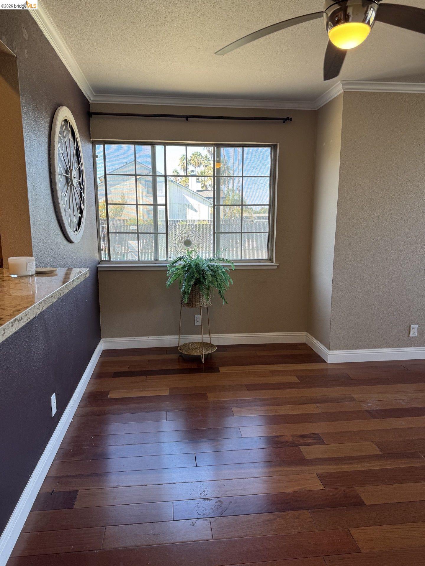 3623 Wells Road Oakley, CA 94561 - Photo 13 of 75 Warm wood-finish flooring, crown molding, and a built-in ceiling fan with integrated lighting